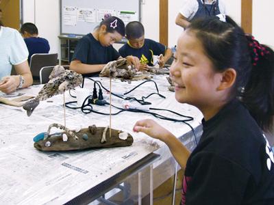 8月に行われた川の楽校「流木で作る水のいきもの」の様子 